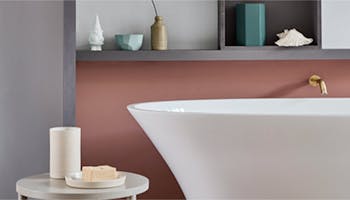 Close up bathtub with warm neutral walls behind