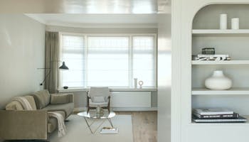 Living room space with a sofa and an armchair on a rug